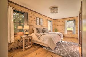 a bedroom with wooden walls and a bed and a table at Pool, Games and Sauna Mount Joy Countryside Cabin in Mount Joy +37 photos