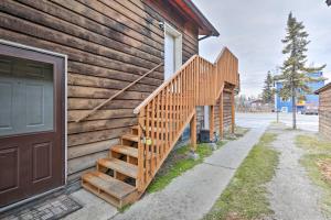 a wooden staircase on the side of a house at Fairbanks Retreat with Massive Deck and Grill! in Fairbanks