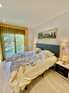 a bedroom with a large bed and a window at CASTELL BLAU in Roses