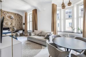 a living room with a couch and a table at WeHost Marble and Brands in the Heart of Helsinki @Vuorikatu 8 in Helsinki
