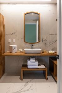 a bathroom with a sink and a mirror at Roso Guest House in Mexico City
