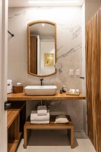 a bathroom with a sink and a mirror at Roso Guest House in Mexico City