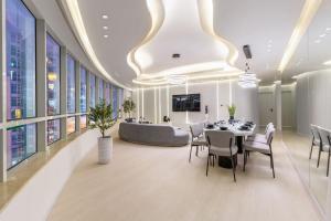 a dining room with a table and chairs and a couch at Vacationer Holiday Homes I Stunning 4 Bed I 10 Min from Marina Mall in Dubai +34 photos