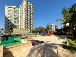 a park with a playground in a city with tall buildings at Aconchegante Flat com Varanda Grande e Vista Linda da Barra B1-0030 in Rio de Janeiro