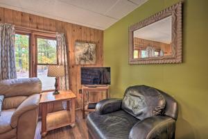 a living room with a couch and a tv and a mirror at Rustic Clint Eastwood Ranch Apt by Raystown Lake in Huntingdon