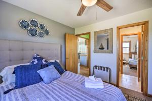 ein Schlafzimmer mit einem Bett mit einer blauen Bettdecke in der Unterkunft Lovely Avon Home Walk to Bay and Boat Launch! in Avon
