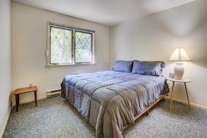 a bedroom with a bed and a window at Charming Gaylord Getaway about 2 Mi to Golfing in Gaylord