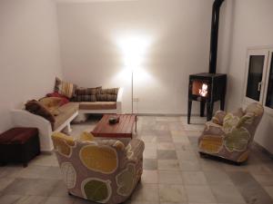 a living room with couches and a wood stove at Casa Ana in Carboneras