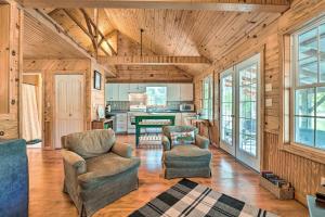 a living room with two chairs and a table at Idyllic Cabin with Fire Pit, Kayak On-Site! in Bells