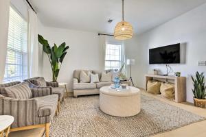 a living room with two couches and a tv at Modern and Chic Gulfport Escape Walk to Beach! in Gulfport