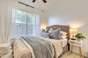 a bedroom with a large bed and a window at Modern and Chic Gulfport Escape Walk to Beach! in Gulfport