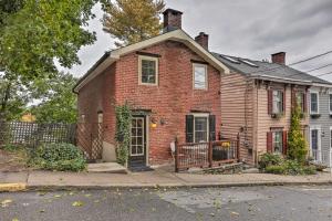 a red brick house with a gate on a street at Historic Home in Lambertville Walk to Bridge in Lambertville