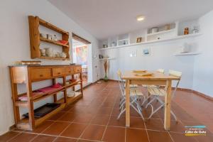 a dining room with a table and a table and chairs at CASA ESCUELA PLAYA in San José +10 photos