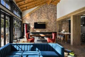 a living room with a blue couch and a table at The Estate Yountville in Yountville