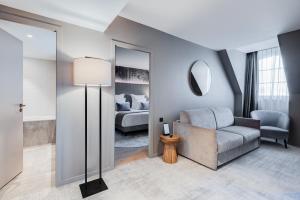 a living room with a couch and a bed at Fleur de Loire in Blois +65 photos