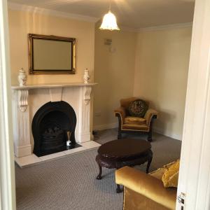 a living room with a fireplace and a mirror at Stunning 5-Bed House in Clones in Cluain Eois