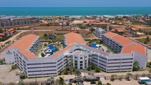 an aerial view of a large building on the beach at Porto das Dunas Solarium Residence in Aquiraz