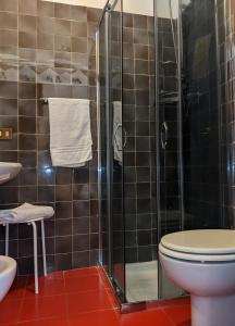 a bathroom with a toilet and a glass shower at Hotel Montecarlo in Castellanza