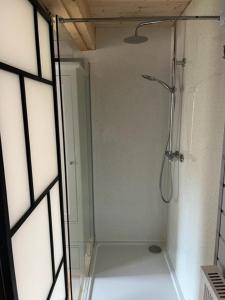 a shower with a glass door in a bathroom at The Snug, Cromer, a short walk to the beach. in Cromer