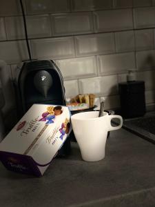 a box and a cup of coffee on a counter at Green park Sandanski in Sandanski