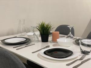 a table with black plates and utensils on it at Green park Sandanski in Sandanski