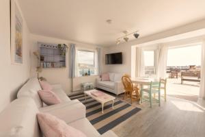 a living room with a white couch and a table at 1 Quayside Court in Swanage