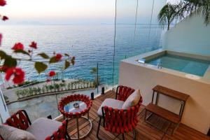 a balcony with a table and chairs and a swimming pool at Hotel Miramare in Vlorë