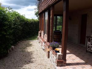 a porch of a house with a flower pot on it at Gîte¨ La Maison du sculpteur ¨ 