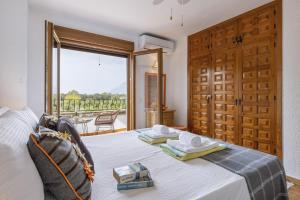 a bedroom with a bed and a large window at Casa Maya in Balcon del Mar +24 photos