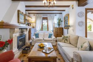 a living room with a couch and a fireplace at Casa Maya in Balcon del Mar