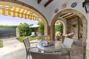 an outdoor patio with a table and chairs and a fireplace at Casa Maya in Balcon del Mar