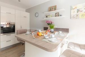 a kitchen with a table with fruits on it at Herzlich Willkommen auf unserem Hof! in Ladbergen