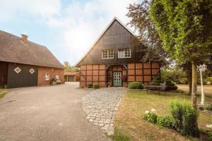 a large house with a driveway in front of it at Herzlich Willkommen auf unserem Hof! in Ladbergen