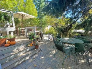 a patio with a table and chairs and an umbrella at Super-modern 1-Bedroom Home Near Downtown SLC in Salt Lake City