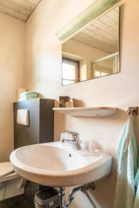 a bathroom with a sink and a mirror at Haus Kathrin in Dorfgastein