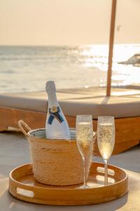a basket with champagne glasses and a bottle on a boat at Wala Hotel and Beach Club in Cartagena de Indias