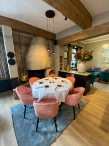 a dining room with a table and orange chairs at Marie Siska Boutique hotel in Knokke-Heist