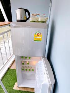 a small refrigerator with its door open in a room at Lively and cozy canal house ,Entire house in Bangkok