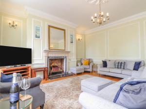 a living room with a tv and a fireplace at Castle View in Marazion