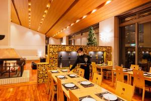 a person sitting at a table in a restaurant at 151 Hakuba by Jade Group in Hakuba