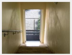 a door leading to a window with a stairway at L'Ulivo Italienische Restaurant und Pension in Pleiskirchen