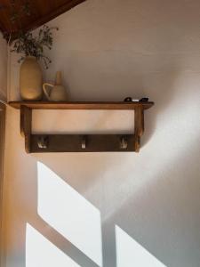 a shelf with vases and vases on a wall at Pousada Vagalume in Tiradentes