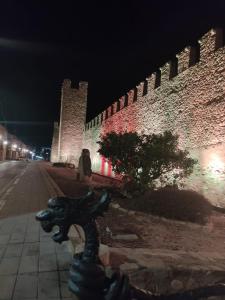 a wall with a statue next to a street at night at Ca L'Aida Rural 2 in Montblanc