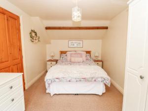 a bedroom with a bed and two night stands at 1 Wildsmith Court in York