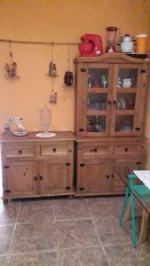 a kitchen with a large wooden cabinet with dishes on it at Sitio Aguá Santa in Itapeva