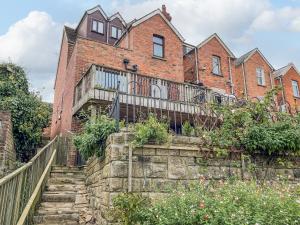 a brick house with a staircase in front of it at Bay View in Swanage