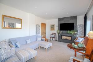 a living room with a couch and a fireplace at Bay View in Swanage