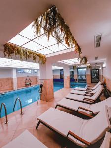 a row of chairs in a room with a pool at Студио "Птича Песен" - Studio "Birdsong", Смолянски езера in Smolyan