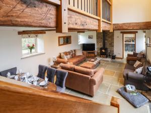 a large living room with couches and a fireplace at Mosscarr Barn in Harrogate