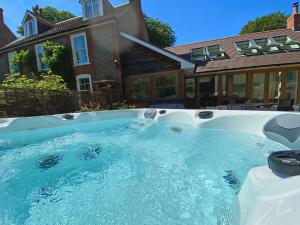 a swimming pool in front of a house at Bailey Cottage in Southampton